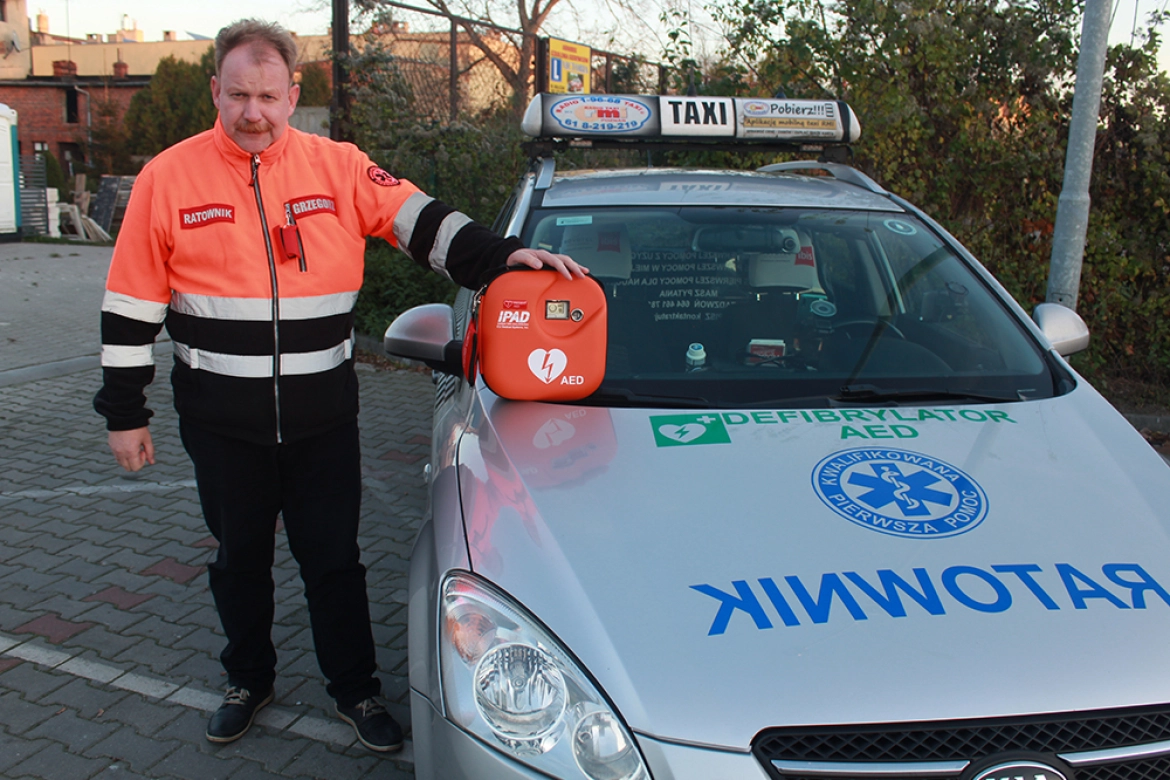 Grzegorz Skuneczny przy swojej taksówce ratunkowej 